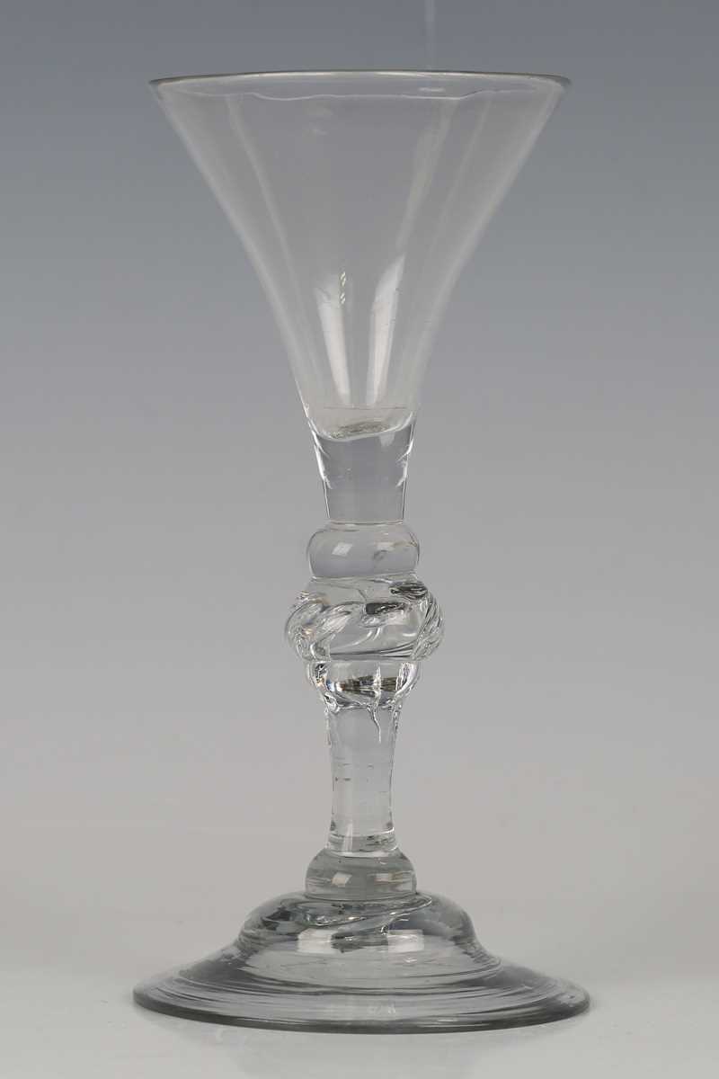 A light baluster wine glass, circa 1740, the drawn trumpet bowl above a flattened knop, the stem