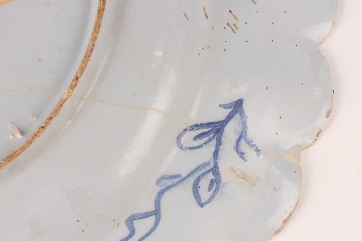 A manganese powdered ground delft dish, Bristol or Wincanton, circa 1740, painted in blue with a - Image 21 of 21