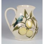 A Moorcroft Finches on Lemons pattern jug, dated 1989, designed by Sally Tuffin, green painted and