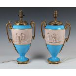 A pair of Sèvres style ormolu mounted porcelain lampbases, circa 1900, both painted with a sepia