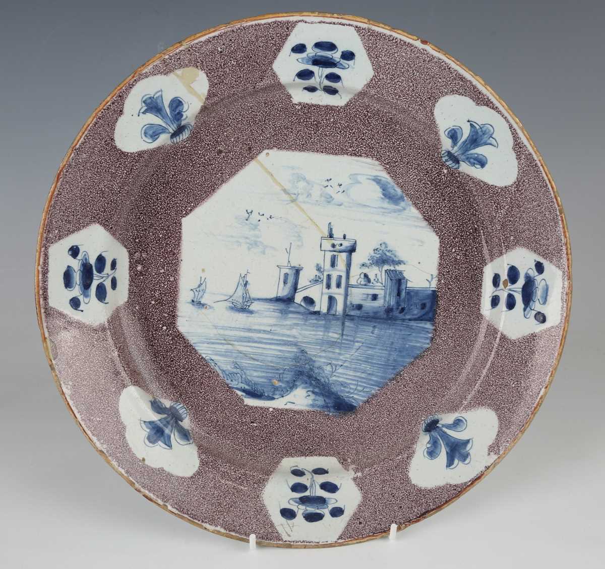 A manganese powdered ground delft dish, Bristol or Wincanton, circa 1740, painted in blue with a - Image 2 of 21