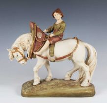 A Royal Dux equestrian figure group, early 20th century, modelled as a young peasant boy seated