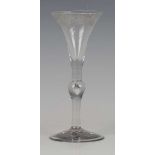 An engraved Kit Kat type wine glass, circa 1730, the drawn trumpet bowl with a band of fruiting vine