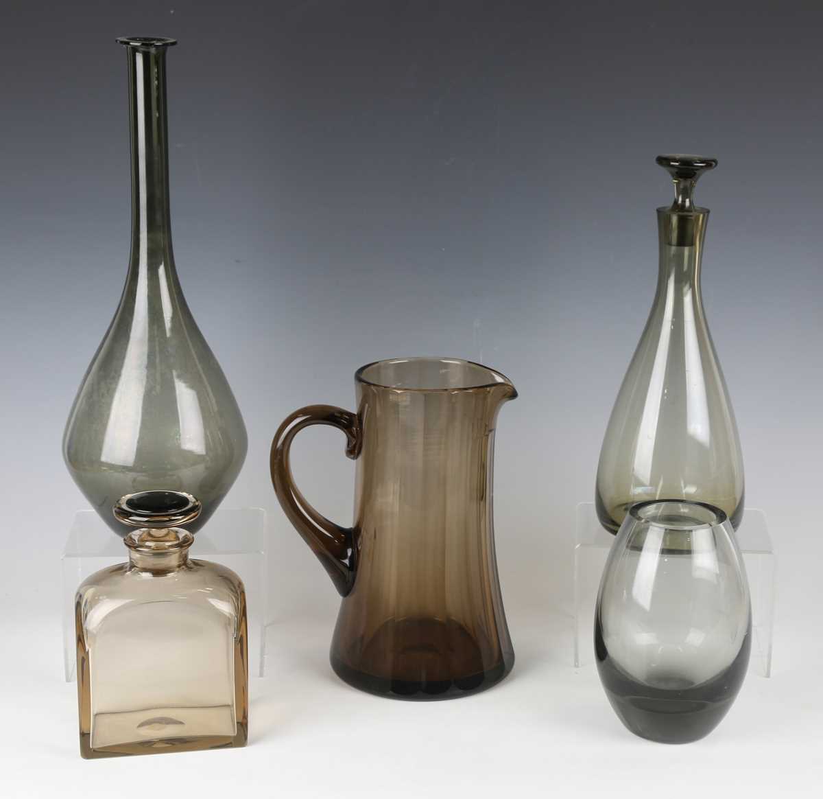 A pair of glass decanters and stoppers, probably Scandinavian, the pear shaped amber glass bodies - Image 2 of 2