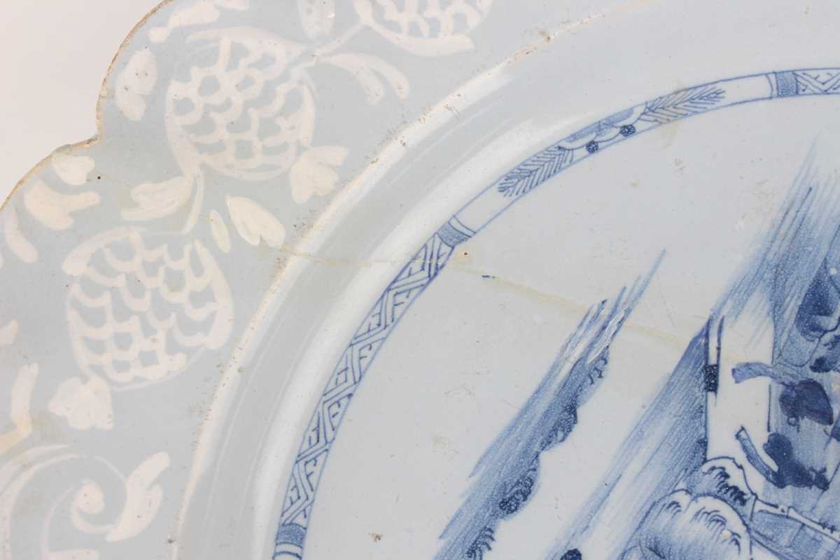 A manganese powdered ground delft dish, Bristol or Wincanton, circa 1740, painted in blue with a - Image 17 of 21