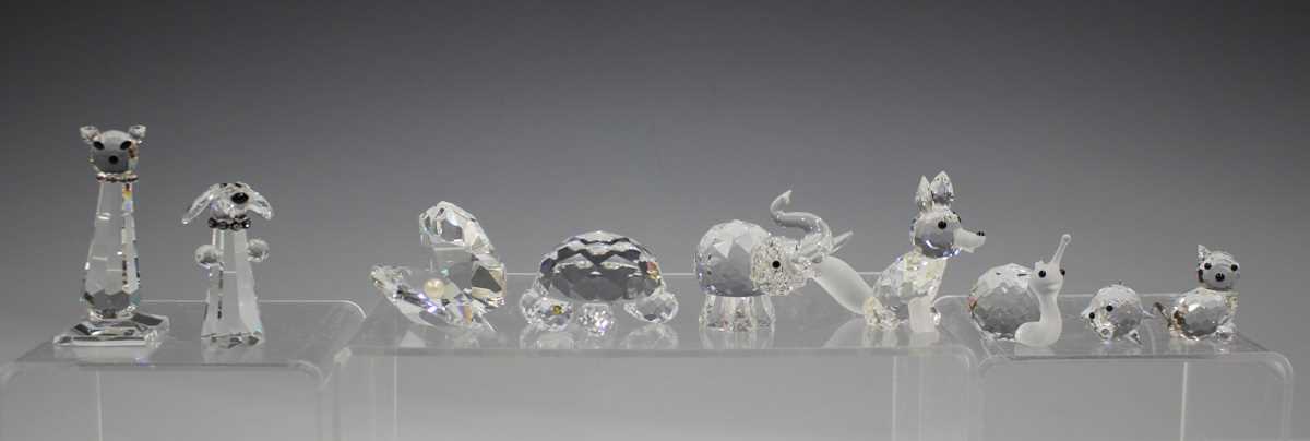 A small group of Swarovski Crystal glass animals, including hedgehog, crown wearing frog, mouse, two