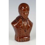 A brown glazed pottery money box, 19th century, modelled as a half-length titled bust of Robert