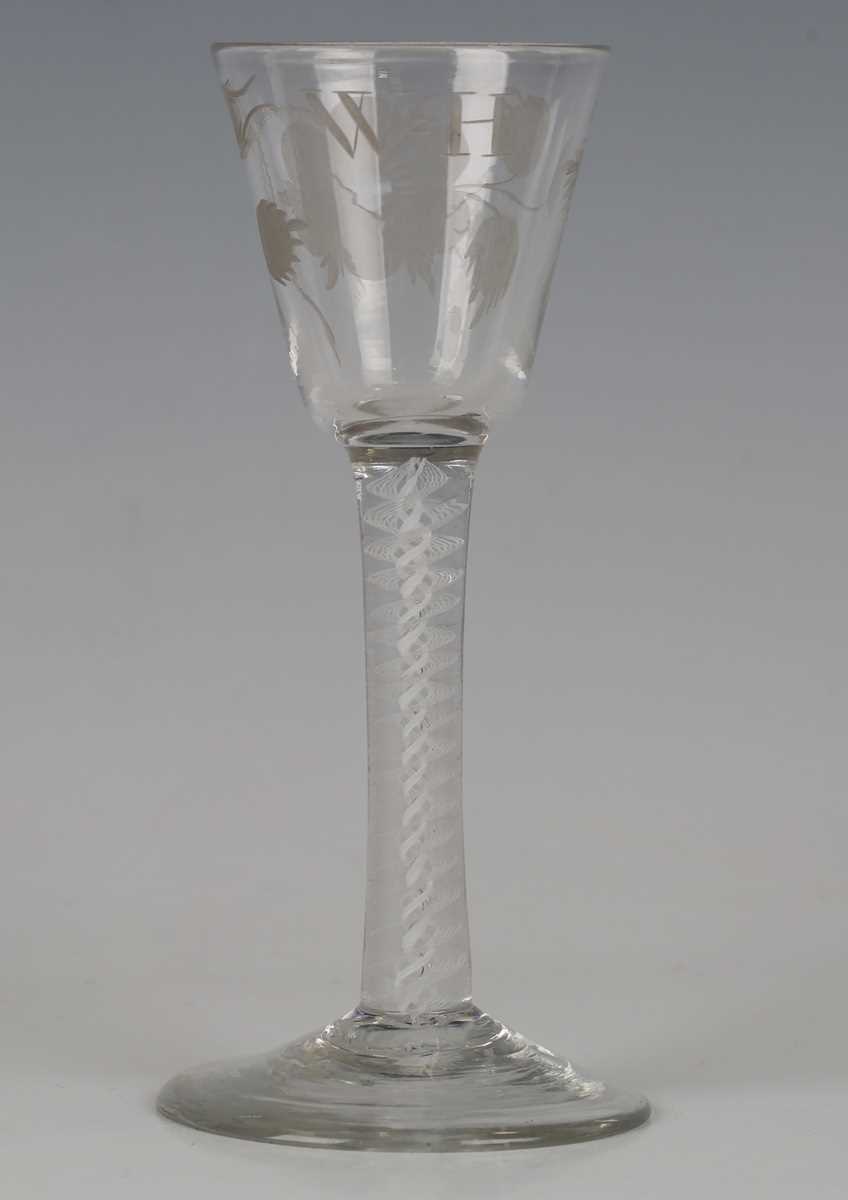 A pair of engraved double series opaque twist stem wine glasses, circa 1765, the rounded funnel - Image 4 of 5