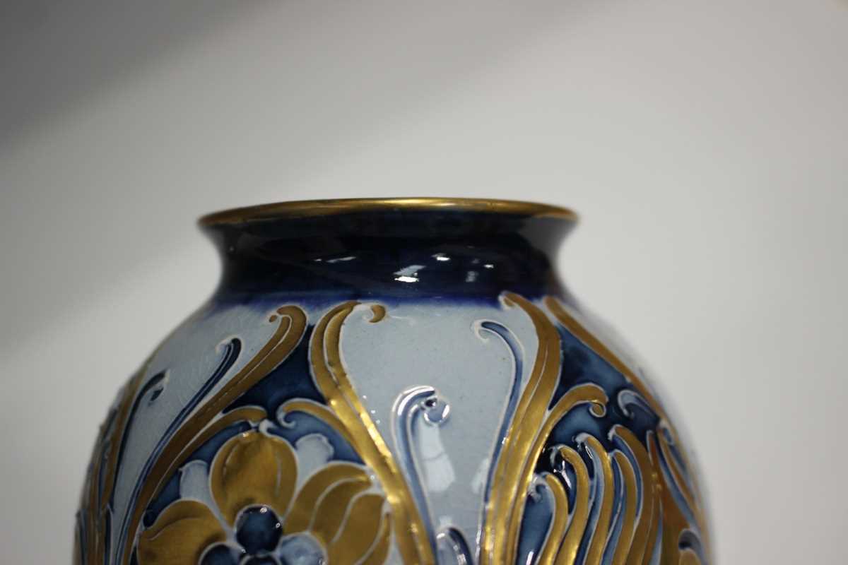 A pair of Macintyre Moorcroft blue and gold Florian design vases, early 20th century, with tall - Image 6 of 6