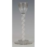 A double series opaque twist stem cordial glass, circa 1770, the ogee bowl engraved with fruiting