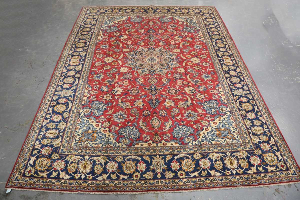 An Esfahan carpet, Central Persia, late 20th century, the claret field with a shaped medallion,