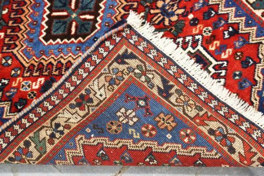 A small Persian rug, late 20th century, the red field with three hooked medallions, within an - Image 5 of 5