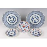 A pair of Japanese Arita blue and white porcelain dishes, Edo period, each painted with a Three