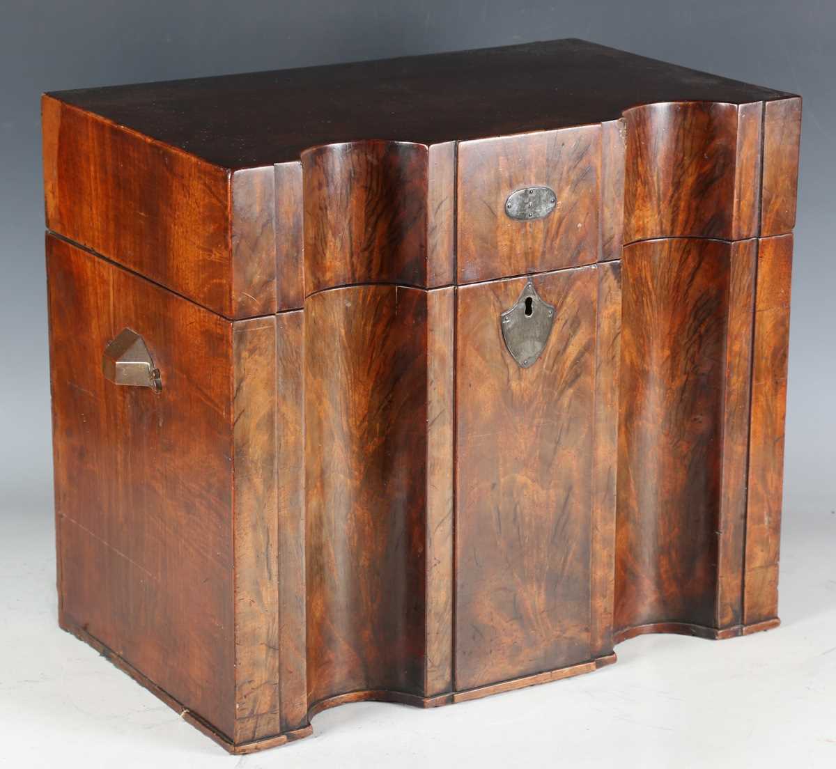 A late George III flame mahogany cellaret or knife box, the hinged lid above a double inverted