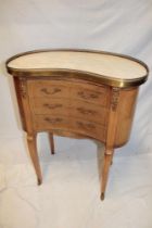 A reproduction French inlaid mahogany kidney-shaped centre chest of three small curved drawers