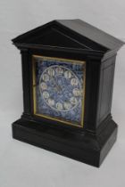 A 19th century mantel clock with blue and white floral ceramic square dial within brass mounted