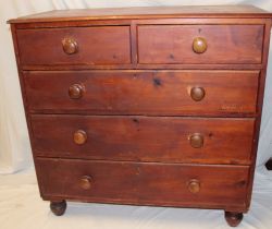 A 19th Century stained pine chest of two short and three long drawers with turned handles on turned