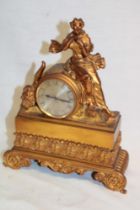 A French mantel clock with silvered circular dial in brass tapered case decorated with a seated