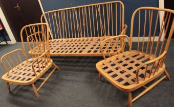 A 1960's Ercol pale elm three-piece suite comprising a three seat sofa and pair of matching
