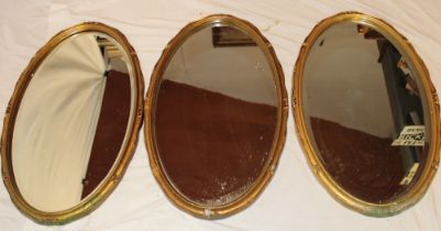 Three matching bevelled oval wall mirrors in gilt frames 27" high