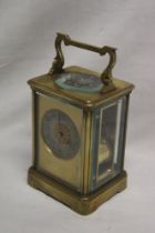 A good quality chiming carriage clock with silvered and gilt decorated circular dial in brass