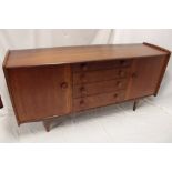 A 1960s teak rectangular sideboard by A Younger Ltd with four short central drawers flanked by