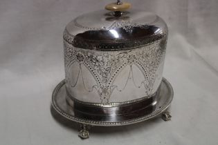 A 19th century silver-plated oval biscuit jar with hinged cover and engraved decoration on claw and