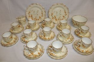 A Victorian china tea set with leaf decoration on cream ground comprising twelve tea cups,