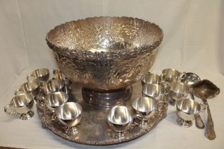 A large silver-plated circular pedestal punch-bowl with raised scroll decoration by Garrard & Co.