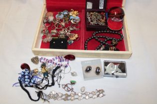 A jewellery box containing a quantity of various costume jewellery,