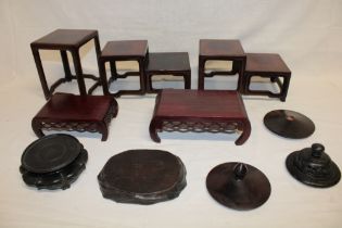 A selection of Eastern wooden ornament and vase stands and three various wooden lids etc