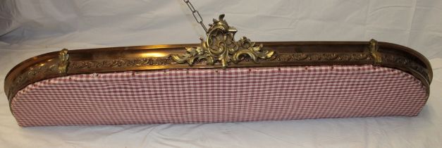 An ornate French brass semi-circular bed canopy with raised scroll decoration 52" long