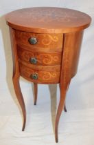 A reproduction French inlaid mahogany circular night stand with three small curved drawers on