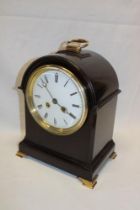 A good quality bracket-style mantel clock with enamelled circular dial in brass mounted mahogany