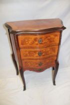 A small reproduction French inlaid mahogany chest of three small drawers with brass mounts on