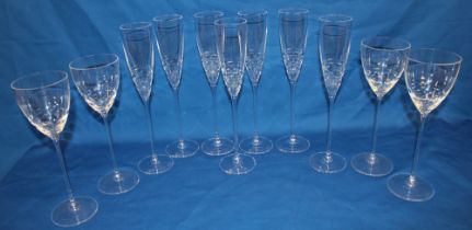 Seven matching Waterford crystal champagne flutes designed by John Rocha, signed,