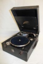 A portable gramophone by Crescendo in black fibre case