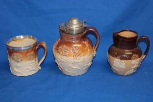 A 19th century stoneware harvest tankard with raised decoration and silver-plated rim;