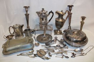 Various silver-plated items including water pots, candlesticks, cutlery,