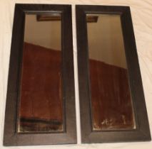 A pair of old rectangular wall mirrors in heavy oak plain frames,