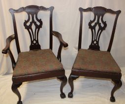 A set of four single and one carver mahogany Chippendale-style dining chairs with pierced vase