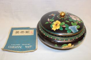 A Chinese cloisonne enamelled circular bowl and cover with floral decoration on black ground 9"