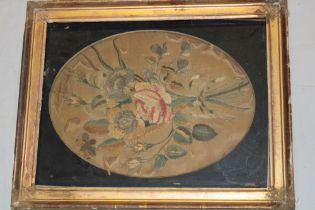 A George III embroidered silk work oval panel depicting flowers,