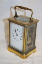 A good quality chiming carriage clock with rectangular enamelled dial in brass traditional glazed