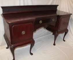 A late Victorian mahogany twin pedestal sideboard with a single-drawer in the frieze on carved