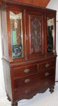 A 19th century Continental mahogany cabinet with cupboard enclosed by a central carved panelled