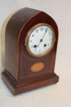 A French mantel clock with silvered circular dial in inlaid mahogany gothic arched case