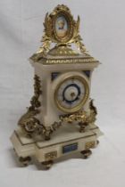 A good quality French brass mounted marble chiming mantel clock with decorated circular dial by J W