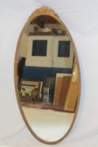 A good quality oval wall mirror in gilt floral decorated frame,