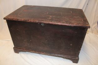 A 19th century stained pine rectangular coffer with hinged lid on bracket feet,